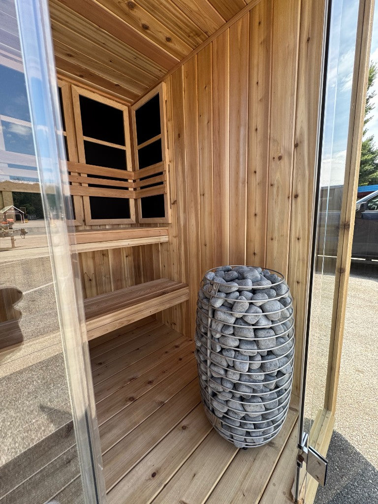 Glass door, cedar benches, and the stone heater