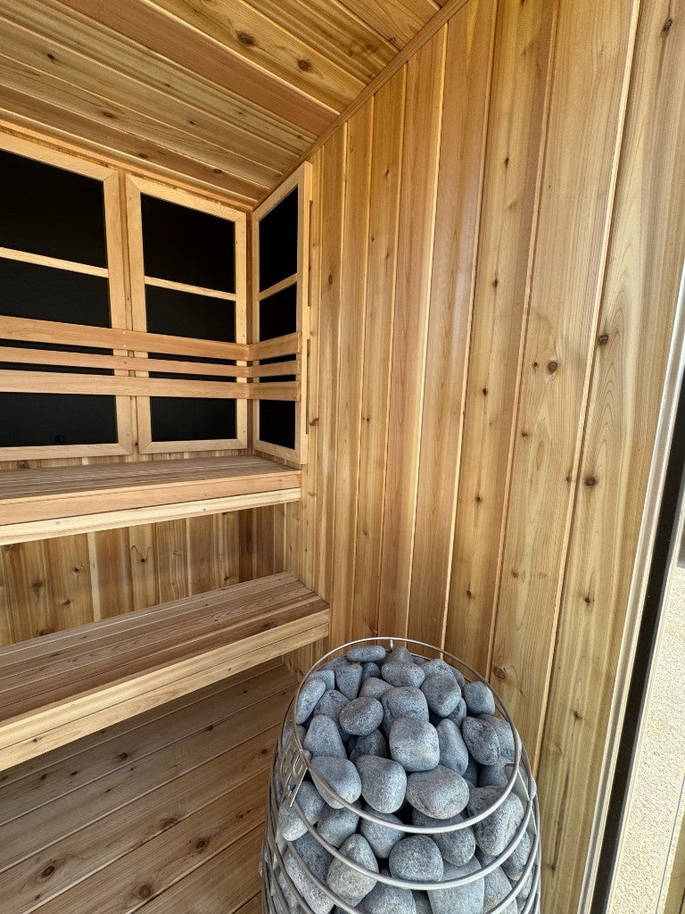 Stone heater basket in the corner of the sauna