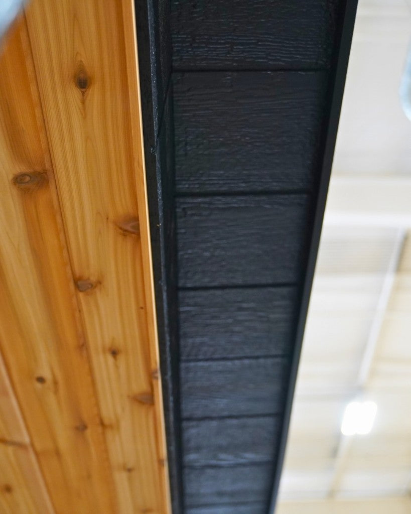 Knotty cedar meeting the black exterior